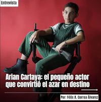 a young boy sitting in a chair with a red background