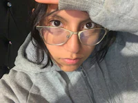 a woman wearing glasses and a hoodie