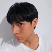 a young man wearing a white t - shirt and black short hair