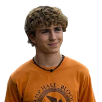a young man with curly hair wearing an orange shirt